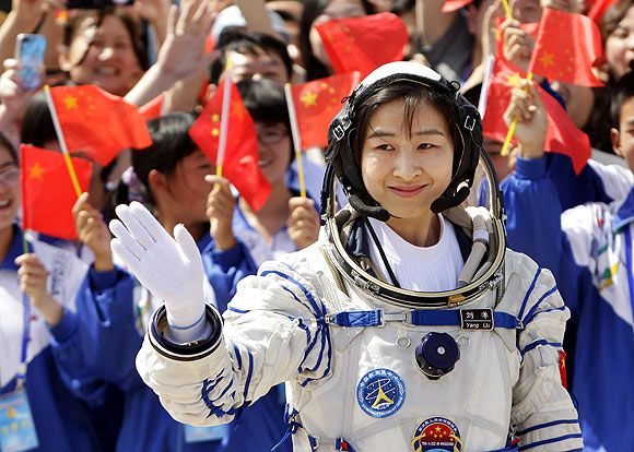 Liu Yang, China's first female astronaut, waves during a departure ceremony at Jiuquan Satellite Launch Center, Gansu province, June 16