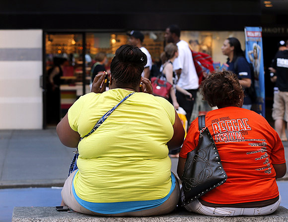 Women sit on a bench in New York's Times Square