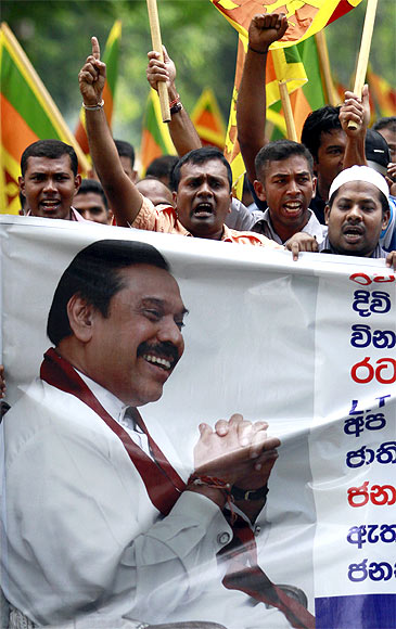 A demonstrator holds up an image of Sri Lanka's president Mahinda Rajapaksa in front of the United Nations (UN) head office during a protest in Colombo