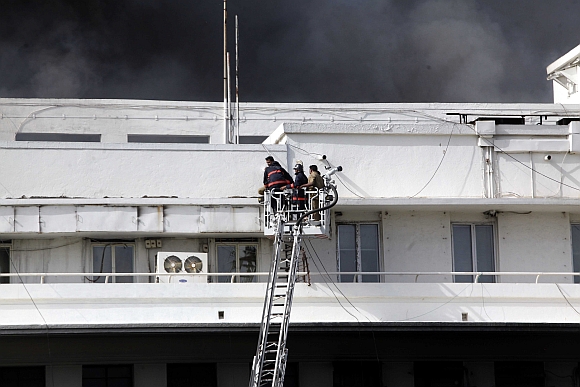Firemen rescue those trapped in the fire at Mantralaya