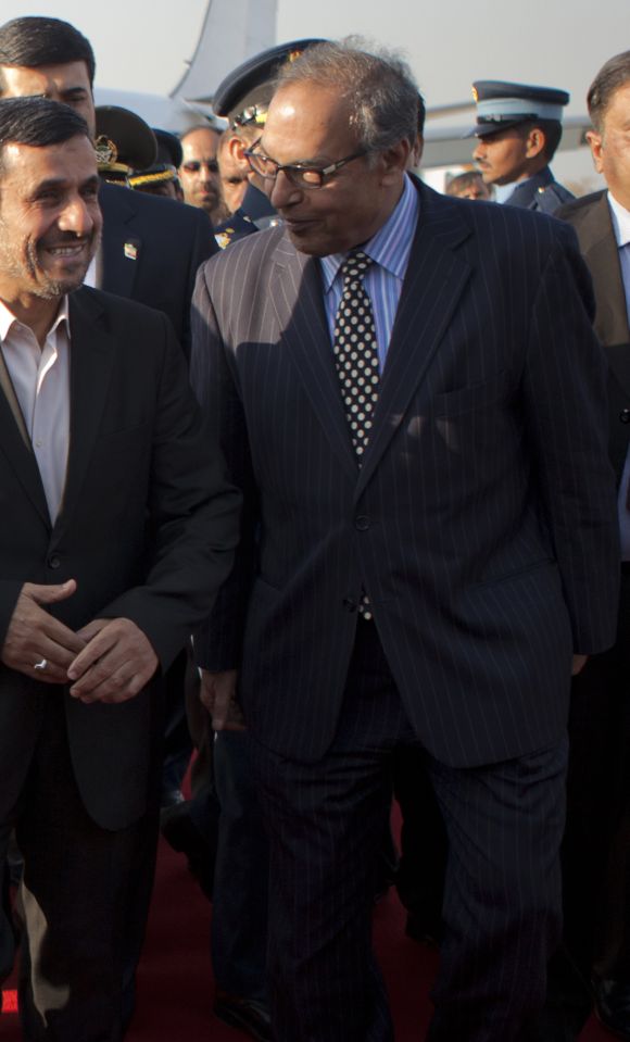 Iran's President Mahmoud Ahmadinejad (L) is escorted by Minister of Textile Industries Makhdoom Shahabuddin after arriving in Rawalpindi