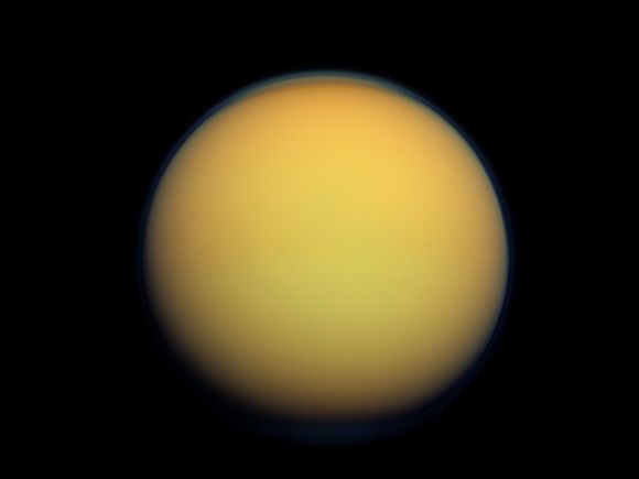 Titan's atmosphere makes Saturn's largest moon look like a fuzzy orange ball in this natural color view from the Cassini spacecraft.