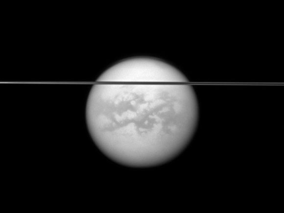 Saturn's rings cut across this view of the planet's largest moon, Titan.