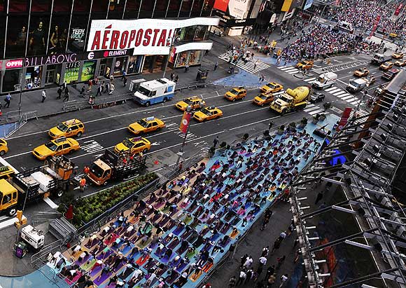 People practice yoga on the morning of the summer solstice in New York's Times Square