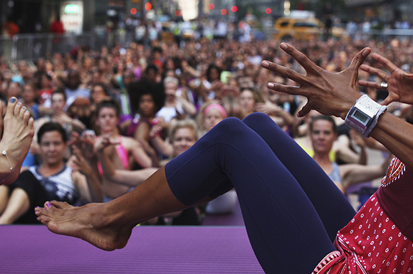 People practice yoga in New York's Times Square