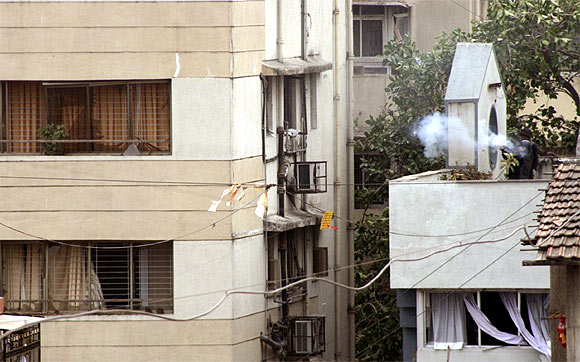 A NSG commando fires at terrorists inside Nariman House in November, 2008