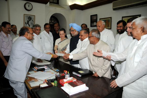 Pranab Mukherjee, flanked by UPA leaders and the PM, files his nomination for the President's post