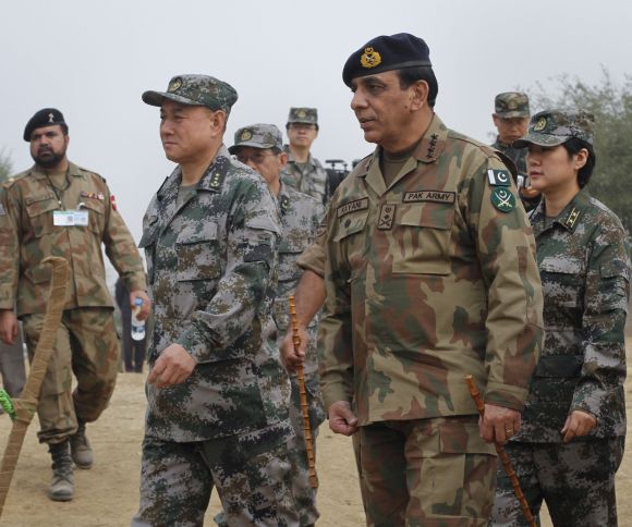 Pakistani Army Chief General Kayani walks with Chinese General Hou after meeting soldiers taking part in joint military exercises in Jhelum, in Pakistan's Punjab province