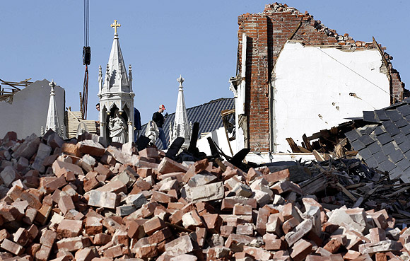 A man takes part in the clean up of St. Joseph's Catholic Church which was destroyed by a tornado in Ridgway, Illinois