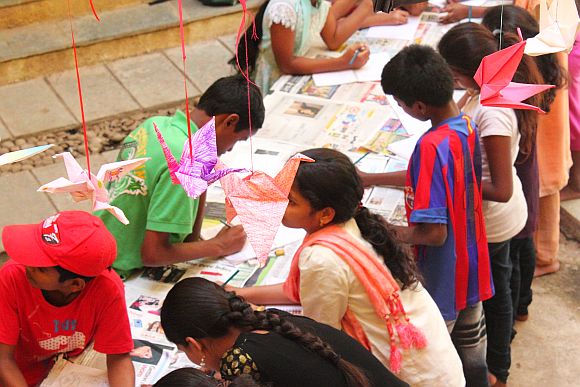 Underprivileged children busy making origami cranes during the 1000 Crane Project in Mumbai