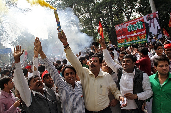 Supporters of Samajwadi Part celebrate outside their party's headquarters in Lucknow