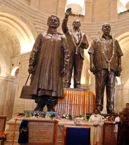 Mayawati poses under the statues of Dalit icons B R Ambedkar, Kanshi Ram and of herself