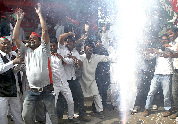 Workers of the Samajwadi Party celebrate in Lucknow