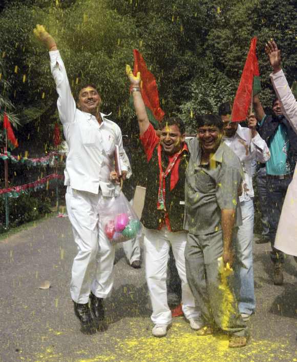Samajwadi Party supporters celebrate in New Delhi