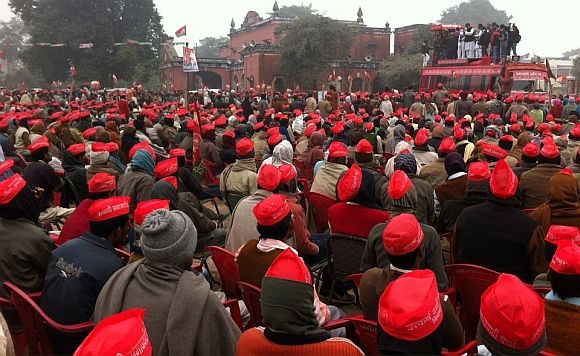 Samajwadi Party supporters listen to Akhilesh Yadav during an election meeting