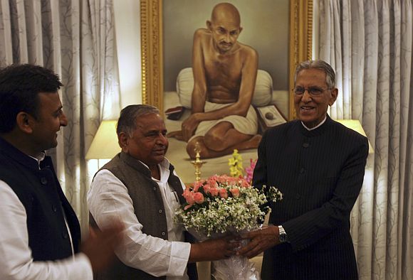 Samajwadi Party leaders Akhilesh Yadav and Mulayam Singh Yadav with UP Governor B L Joshi