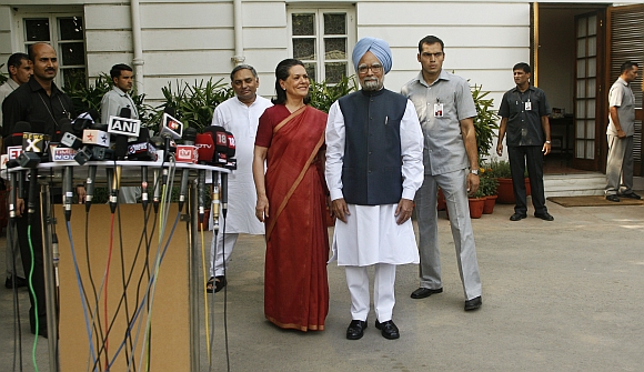 Congress Party chief Sonia Gandhi and Prime Minister Manmohan Singh pose for photographers at 10, Janpath in New Delhi