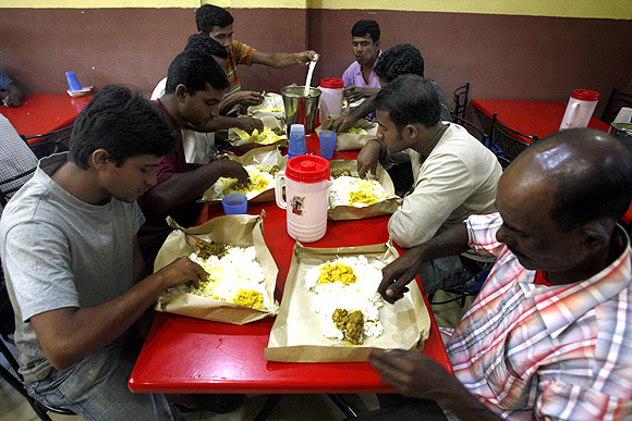 Labourers from Bangladesh eat dinner at a restaurant in Singapore's Little India