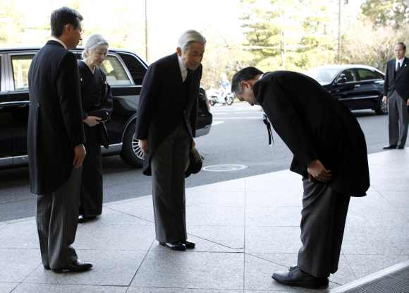 Japan's Emperor Akihito and Empress Michiko arrive for a memorial ceremony marking the first anniversary of the March 11, 2011 earthquake and tsunami, in Tokyo