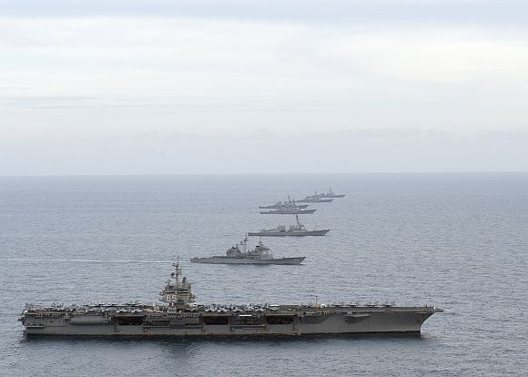 The aircraft carrier USS Enterprise (CVN 65), bottom, the Ticonderoga-class guided-missile cruiser UDD Vicksburg (CG 69), the Arleigh Burke-class guided-missile destroyers USS James E. Williams (DDG 95), USS Porter (DDG 78), USS McFaul (DDG 74), USS Cole (67) and USS Nitze (DDG 94) maneuver into formation during the Enterprise Carrier Strike Group's composite training unit exercise.