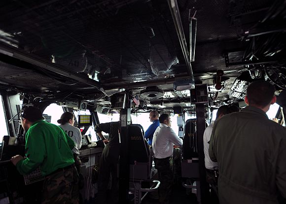 Sailors track the recovery of an aircraft in primary flight control during flight operations aboard the aircraft carrier USS Enterprise