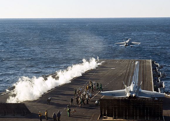 An F/A-18F Super Hornet, assigned to the Red Rippers of Strike Fighter Squadron (VFA) 11, takes off from the flight deck of the aircraft carrier USS Enterprise