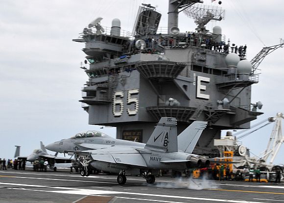 An F/A-18F Super Hornet assigned to the Checkmates of Strike Fighter Squadron 211 lands aboard the aircraft carrier USS Enterprise
