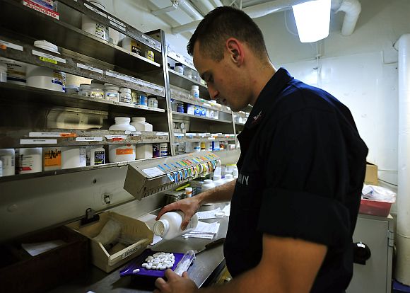 The hospital corpsman inventories medicine in the pharmacy aboard the aircraft carrier USS Enterprise