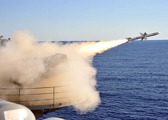 A ship-launched, intercept-aerial guided missile is launched from a NATO Sea Sparrow launcher during a live-fire exercise aboard the aircraft carrier USS Enterprise