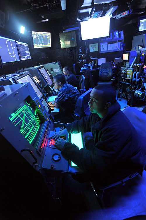 Sailors man their positions in the Carrier Air Traffic Control Centre aboard the aircraft carrier USS Enterprise