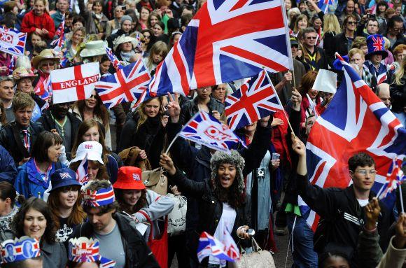 File picture of crowds of people walking towards Buckingham palace in London