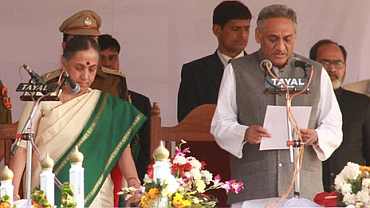 Uttarakhand Governor Margaret Alva administers the oath of office and secrecy to Vijay Bahuguna as the seventh CM of the state