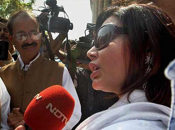 Item girl Rakhi Sawant interacts with the media outside Parliament