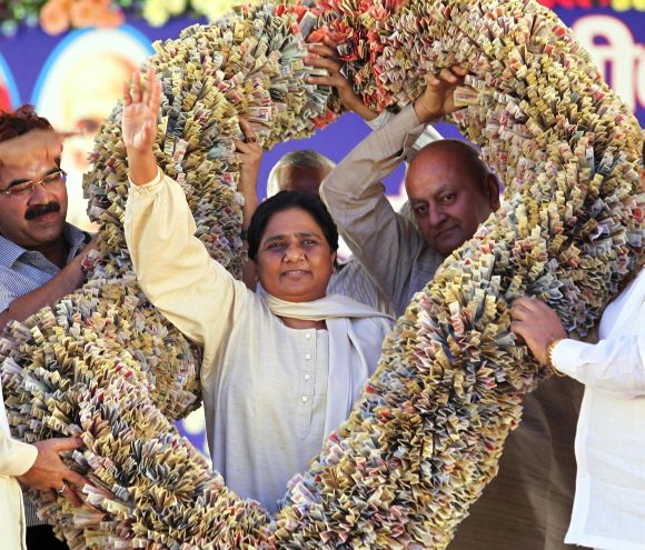 File photograph of former UP chief minister Mayawati receiving a garland made of currency notes from BSP supporters in Lucknow