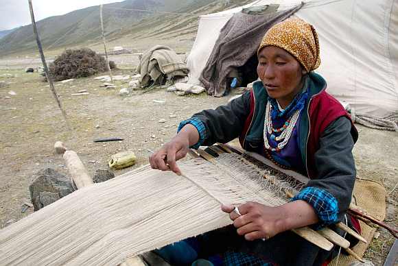 A nomad woman weaves Pashmina at Taglang La in the Ladakh region