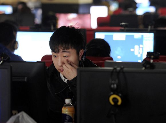 A man uses a computer at an internet cafe in Hefei, Anhui province