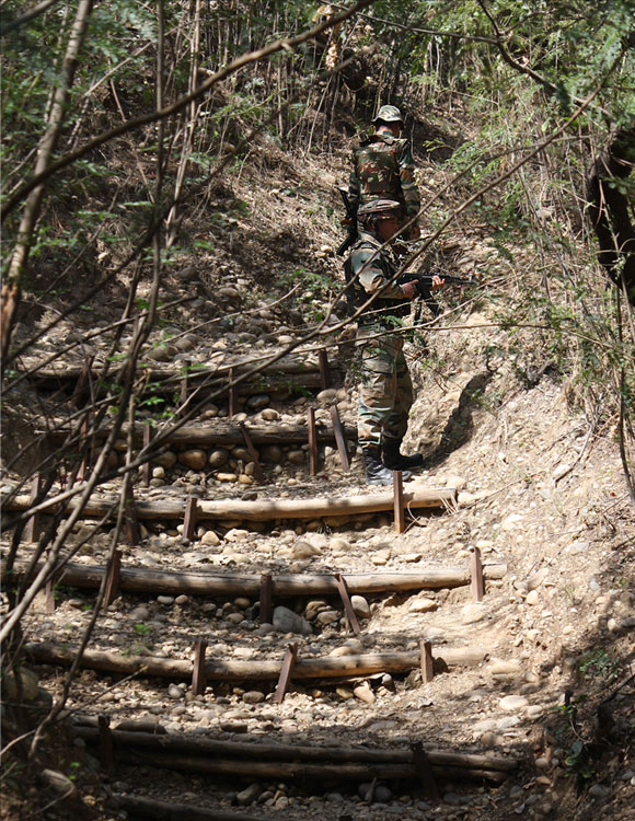 Soldiers walk through a trench used for communication and transporting reinforcements during war.