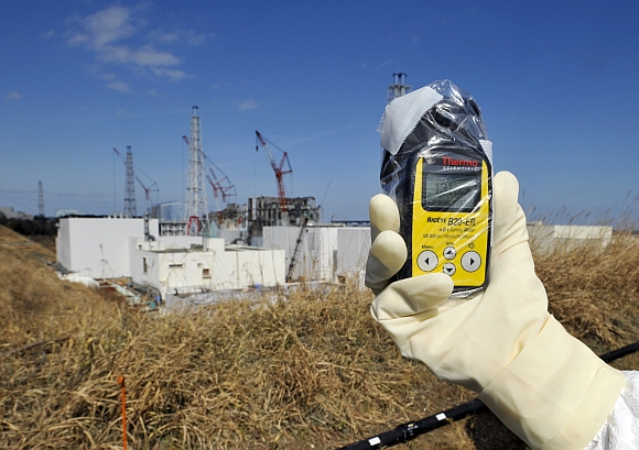 A radiation monitor indicates 131.00 microsieverts per hour near the No 4 and No 3 buildings at the tsunami-crippled Tokyo Electric Power Co's Fukushima Daiichi nuclear power plant in Fukushima