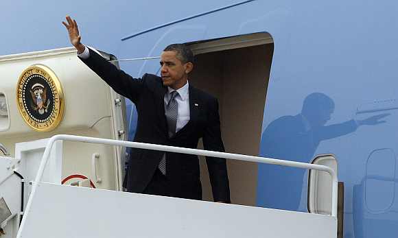 US President Barack Obama waves from Air Force One at Andrews Air Force Base