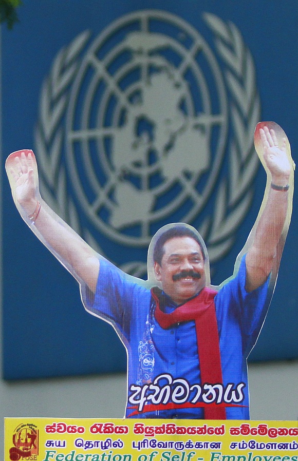 A demonstrator holds up an image of Sri Lanka's president Mahinda Rajapaksa in front of the United Nations head office during a protest in Colombo