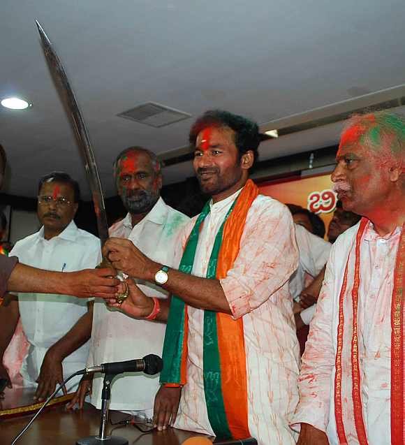 BJP Andhra President  G Kishan Reddy shows a sword after victory in the Mahabubnagar district
