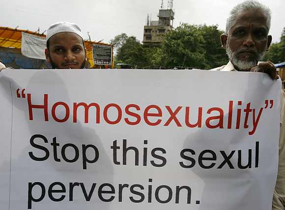 Activists of Students of Islamic Organisation hold placards during a demonstration against homosexuality