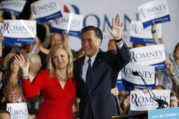 US Republican presidential candidate Romney waves to supporters with his wife Ann in Illinois