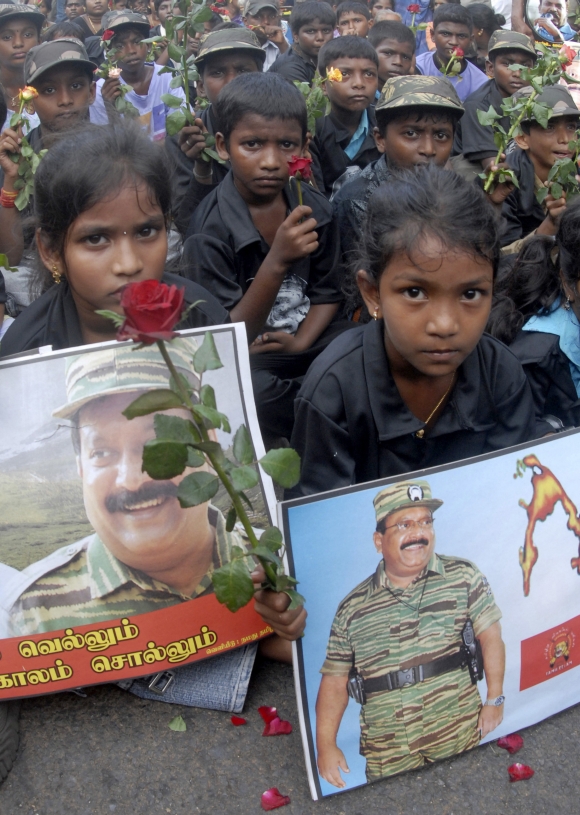 Children hold pictures of slain LTTE leader Vellupillai Prabhakaran during a protest rally against Sri Lanka's President Mahinda Rajapaksa