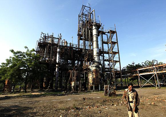 A security guard walks in front of the Union Carbide Corp, now part of Dow Chemical Co, pesticide plant in Bhopal