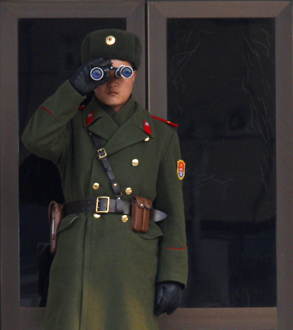 A North Korean soldier watches the South Korean side at the border village of Panmunjom in the DMZ