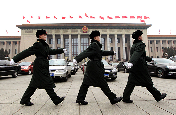 Soldiers of the Chinese People's Liberation Army march in front of the Great Hall of the People