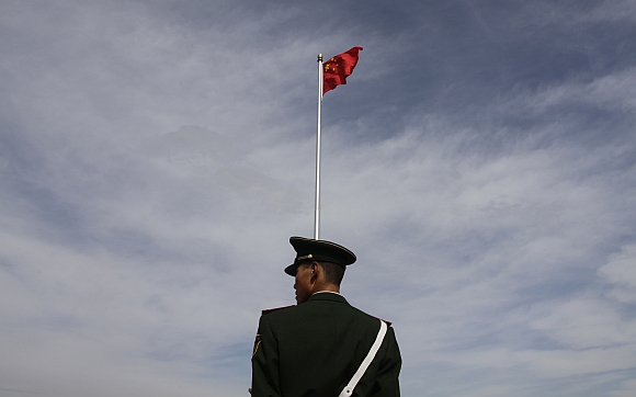 A paramilitary policeman stands guard at Tiananmen Square in Beijing