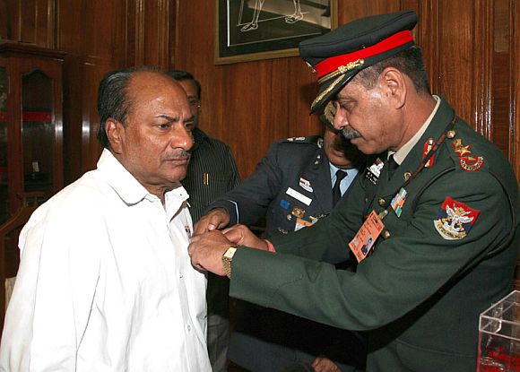 File photo shows Col B K Majumdar of the Kendriya Sainik Board pinning a lapel on the Defence Minister A K Antony, on the occasion of the Armed Forces Flag Day, in New Delhi on December 07, 2011