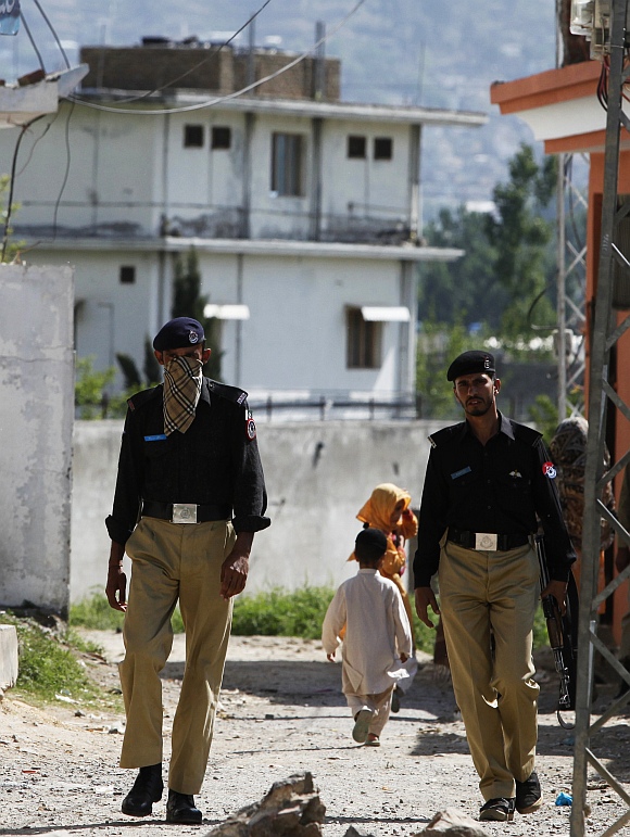 Policemen patrol a street near the compound where al Qaeda leader Osama bin Laden was killed in Abbottabad